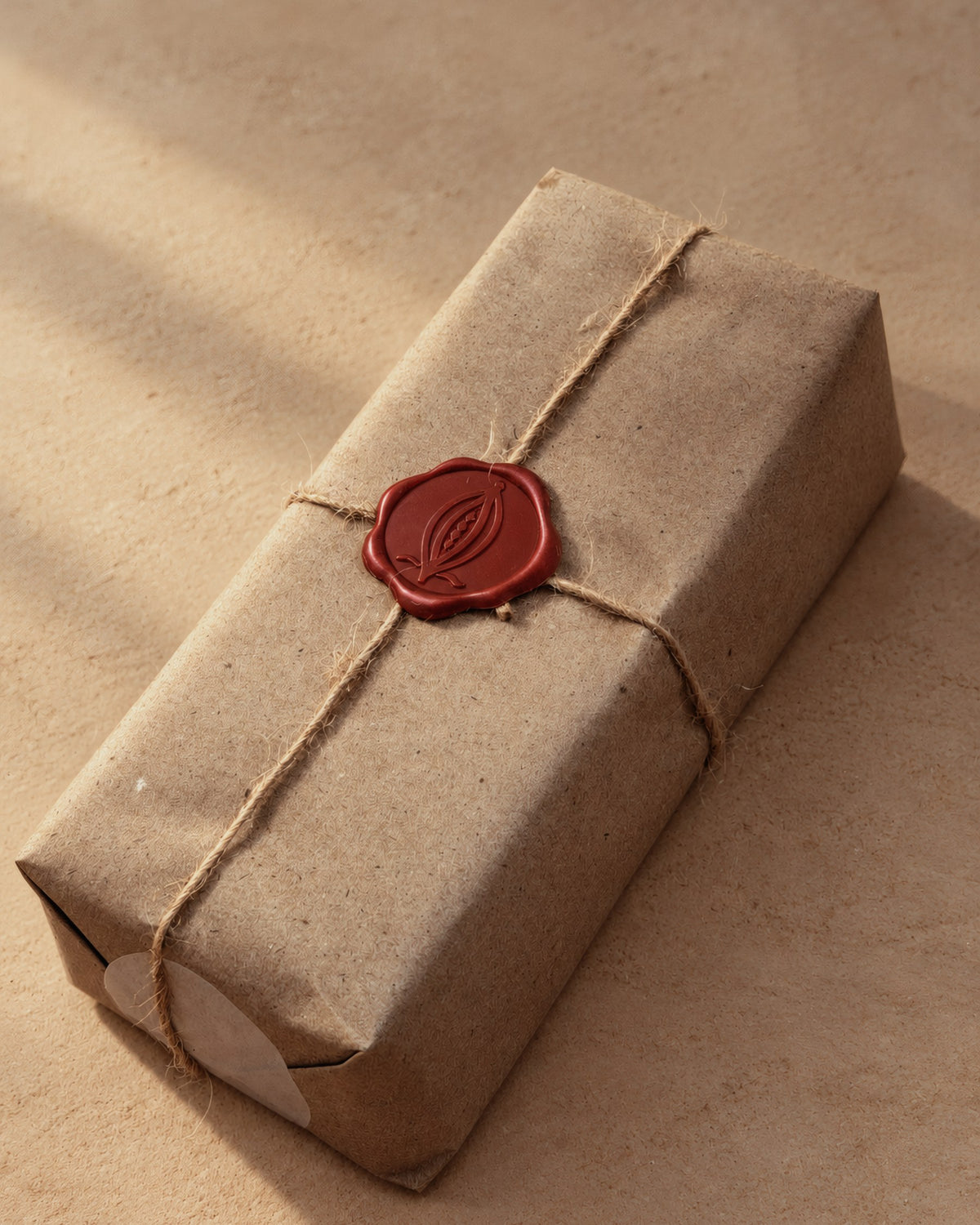 The wrapped one-pound block from the side: kraft paper, twine and the red ALPAKA seal