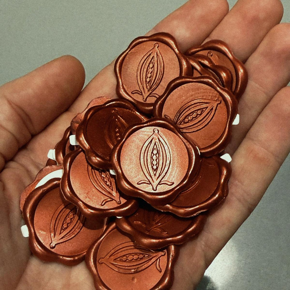 A handful of red wax seals with the ALPAKA pod, one for each block